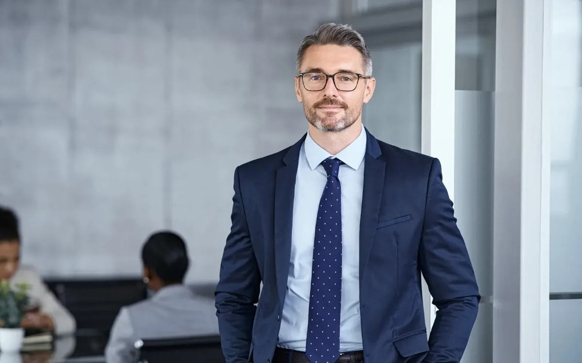 A founder standing in a workspace behind him